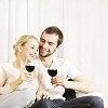 Happy couple sitting and having wine