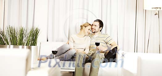 Couple enjoying wine on the sofa