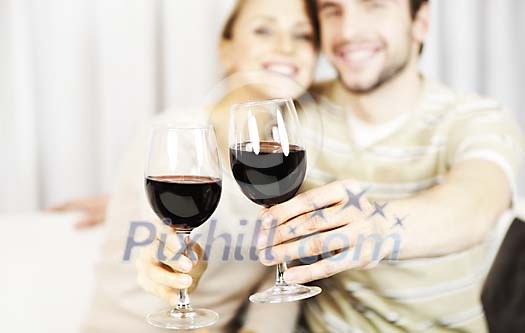 Couple holding wine glasses to the camera