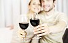 Couple holding wine glasses to the camera