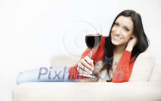 Woman sitting on the couch having a glass of wine