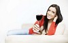 Woman sitting on the couch having a glass of wine