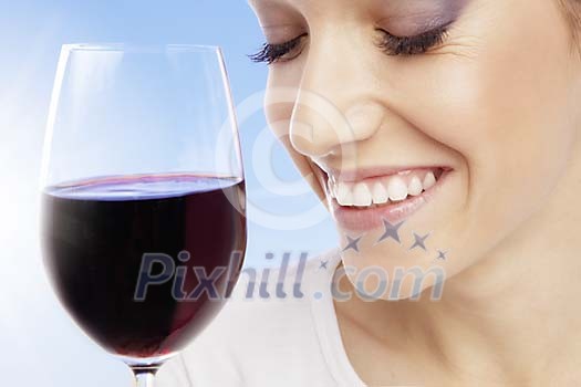 Woman with a glass of red wine on a blue background