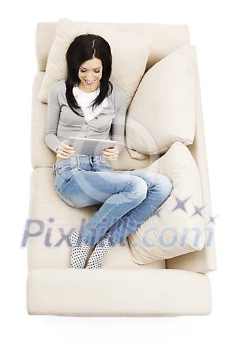 Woman on the couch, reading e-book
