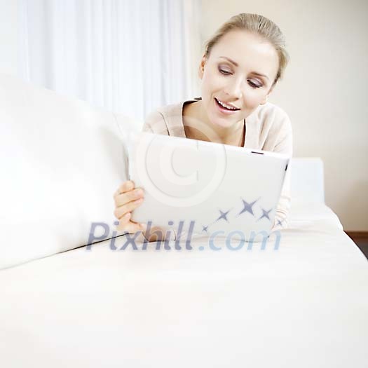Woman with a tablet on the couch