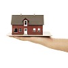 Isolated hand holding a toy house