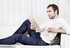 Man reading newspaper on the sofa