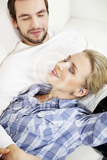 Man and woman taking a nap on the couch Man and woman taking a nap on the couch
