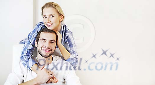 Man sitting on the chair and woman standing behind him