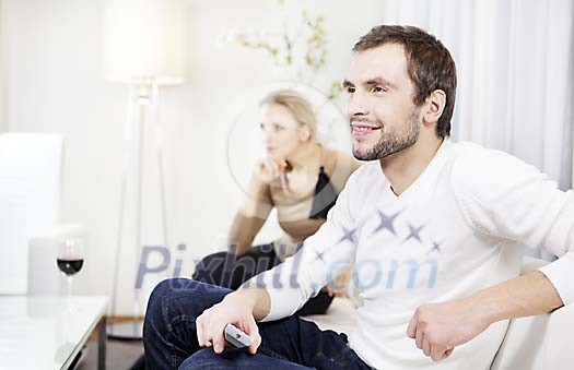 Couple at home watching tv
