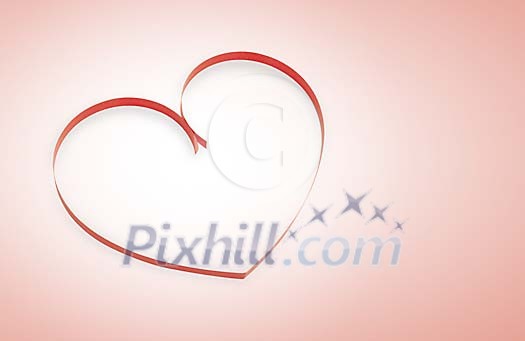 Heart made of ribbon on a pink background