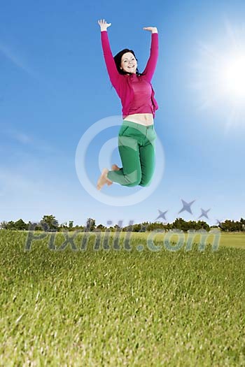 Woman jumping high in the air on the field Woman jumping high in the air on the field