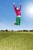 Woman jumping high in the air on the field