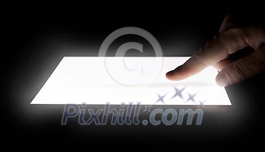 Hand on the lighted touchscreen Hand on the lighted touchscreen