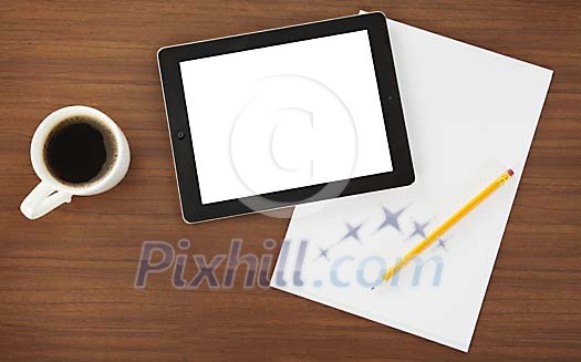 Tablet with paper and cup of coffee on the desk