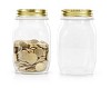 Isolated glass jars, one with coins