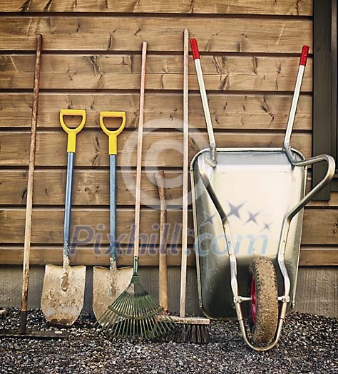 Garden tools by the cottage wall