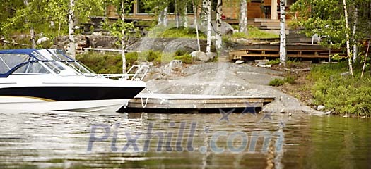 Cottage by the lake with a boat