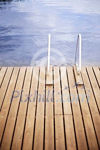 Empty pier with ladder by the water