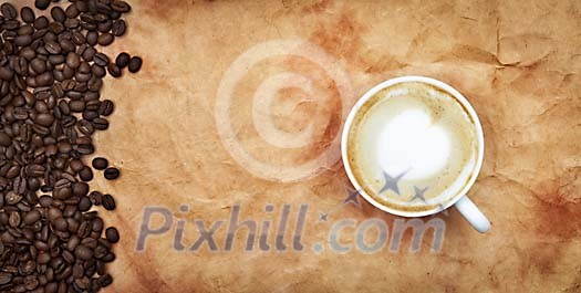 Cup of coffee on a brown paper with coffee beans