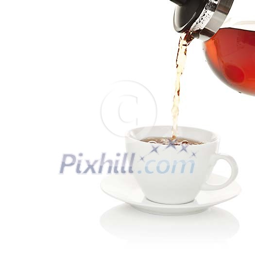 Isolated cup of tea being poured