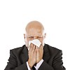Isolated businessman sneezing