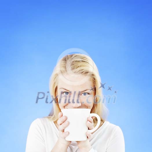 Woman on a blue background drinking coffee