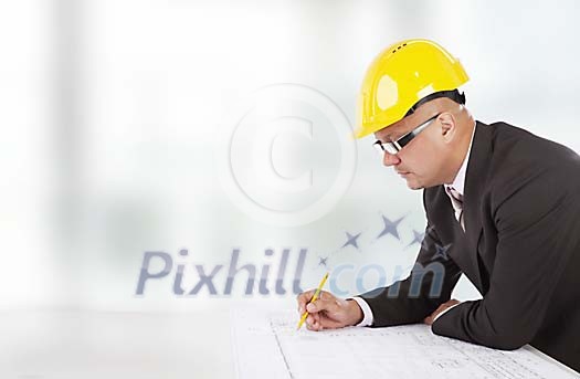 Isolated man checking blueprints