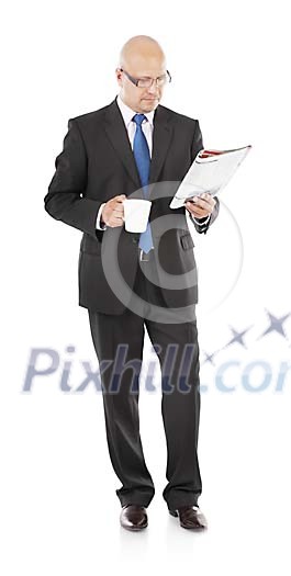Isolated businessman reading a newspaper and drinking coffee