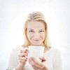 Woman smiling and holding a cup