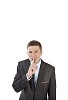 Isolated businessman holding a finger in front of his mouth