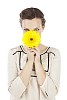 Isolated woman trying to hide behind a flower
