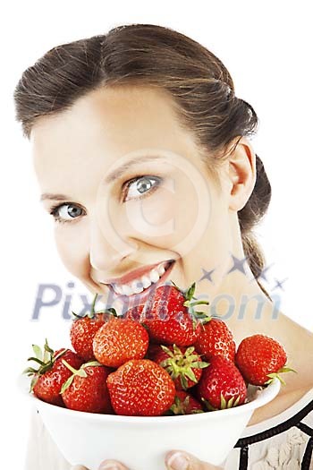 Woman holding a bowl of strawberries and smiling