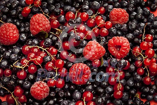 Background of redcurrants, raspberries and blueberries