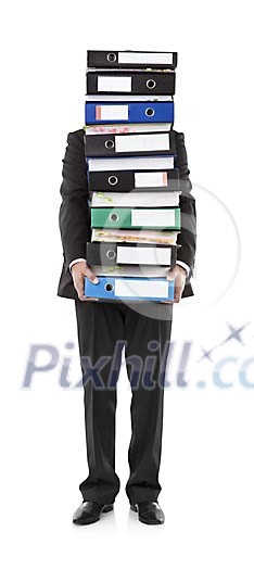 Isolated businessman holding a big pile of binders