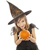 Girl dressed as a witch offering a pumpkin