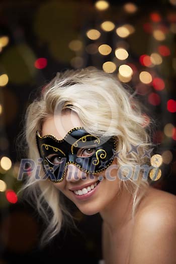 Masked woman on a lighted background