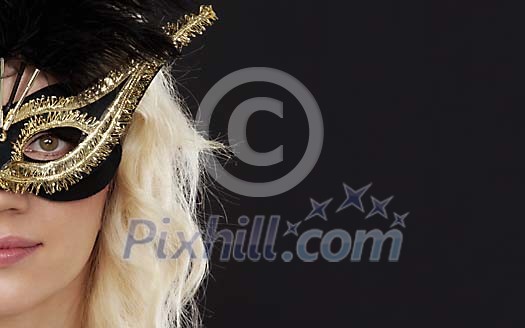 Womans face with a mask on a black background