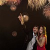 Man and woman under fireworks