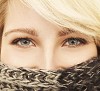 Half womans face covered with a scarf