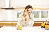 Woman having a juice in the kitchen