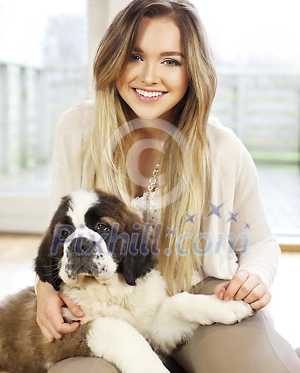 Woman sitting on the floor with a puppy