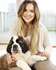 Woman sitting on the floor with a puppy