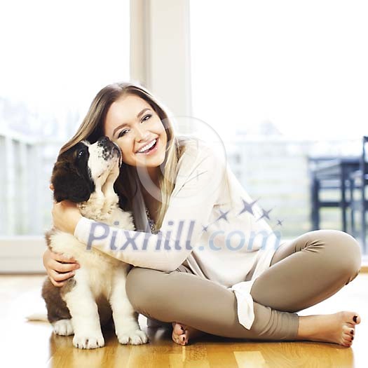 Woman sitting on the floor with a puppy Woman sitting on the floor with a puppy