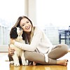 Woman sitting on the floor with a puppy