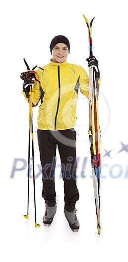 Isolated man standing with skis