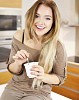 Woman eating youghurt in the kitchen