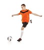 Isolated male footballer going to kick the ball