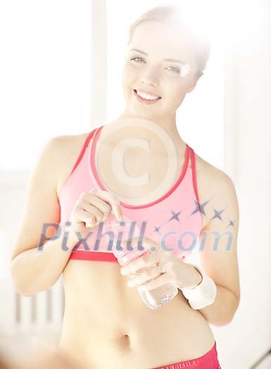 Female holding a bottle of water Female holding a bottle of water