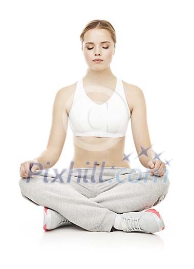 Isolated female meditating on the floor